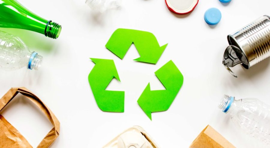 Recyclable materials surrounding a recycling symbol. 