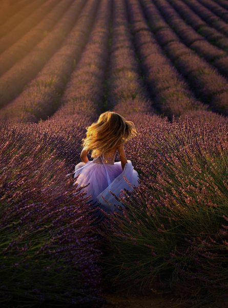 Girl running towards a flower field